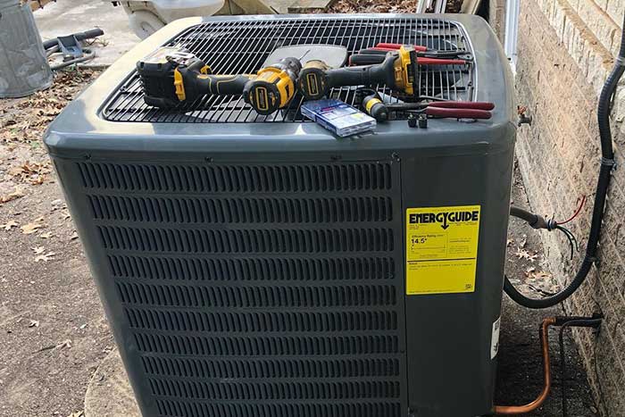 AC unit maintenance with tools on top