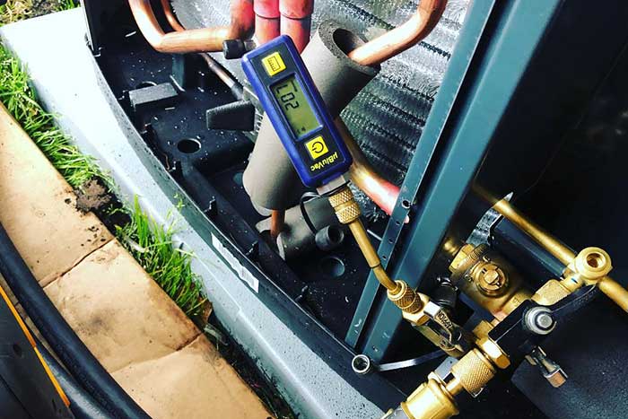 HVAC technician performing AC maintenance