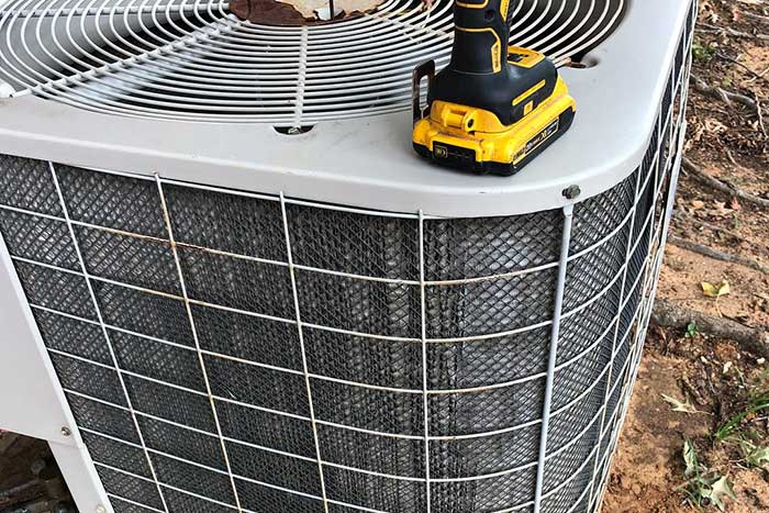AC unit maintenance with power drill