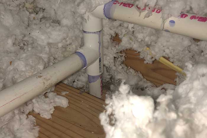 Attic pipes with Spray Foam Insulation Installation.
